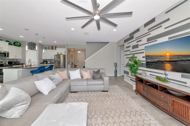 5134 Jackel Chase Dr, Wimauma, FL 33598 - living room with a ceiling fan, recessed lighting, stairway, and an accent wall
