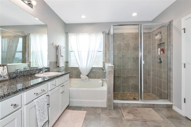 5134 Jackel Chase Dr, Wimauma, FL 33598 - bathroom with vanity, a bath, a shower stall, and healthy amount of natural light