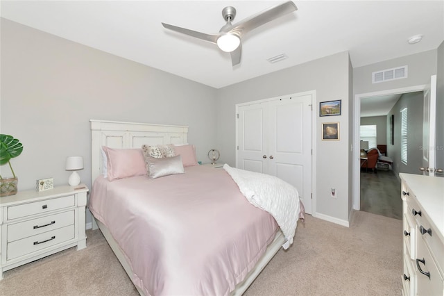 5134 Jackel Chase Dr, Wimauma, FL 33598 - bedroom featuring light colored carpet, a closet, and ceiling fan