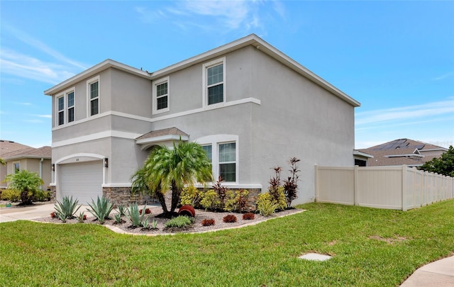 5134 Jackel Chase Dr, Wimauma, FL 33598 - view of front facade with a garage, stucco siding, driveway, and stone siding