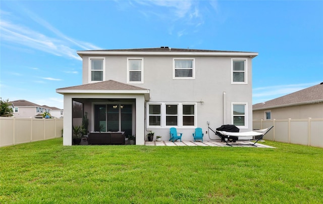 5134 Jackel Chase Dr, Wimauma, FL 33598 - back of property with stucco siding, a fenced backyard, a patio area, and a sunroom