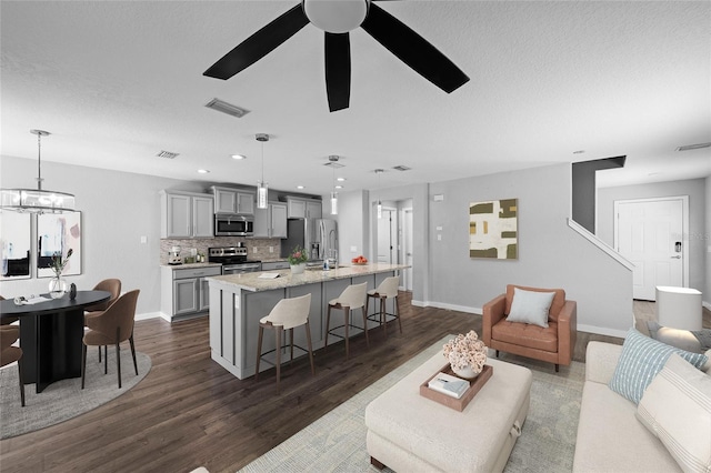 7036 Chatum Light Run, Bradenton, FL 34212 - living area featuring dark wood-style flooring, ceiling fan, recessed lighting, and a chandelier
