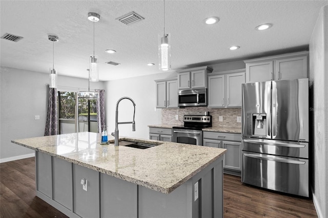 7036 Chatum Light Run, Bradenton, FL 34212 - kitchen with appliances with stainless steel finishes, gray cabinets, dark wood-type flooring, a center island with sink, and recessed lighting