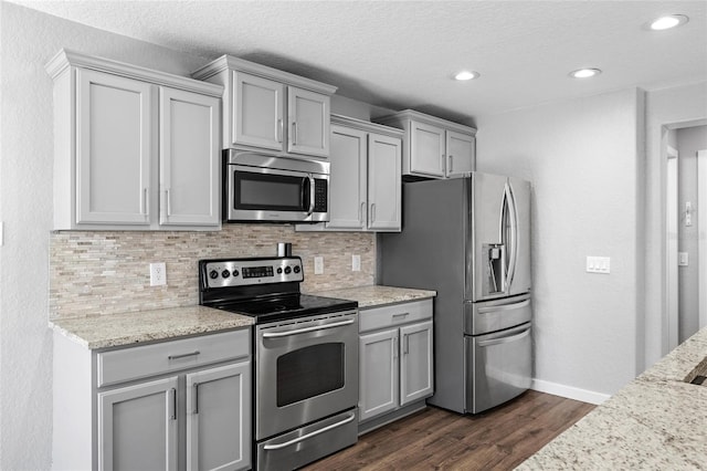7036 Chatum Light Run, Bradenton, FL 34212 - kitchen featuring stainless steel appliances, gray cabinets, backsplash, dark wood finished floors, and recessed lighting