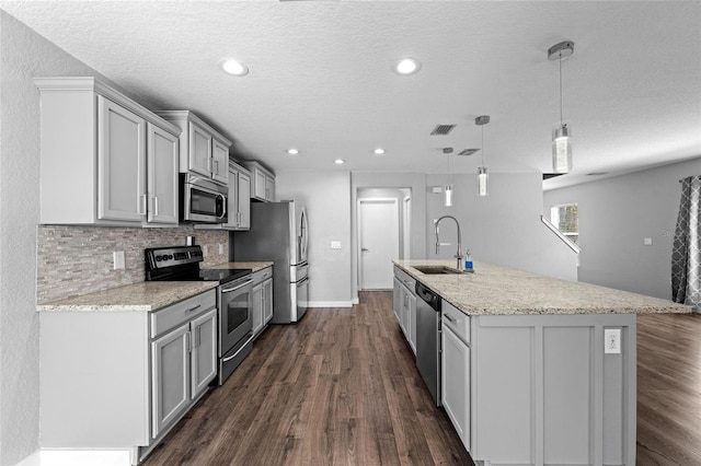 7036 Chatum Light Run, Bradenton, FL 34212 - kitchen featuring appliances with stainless steel finishes, gray cabinets, dark wood-style flooring, tasteful backsplash, and recessed lighting
