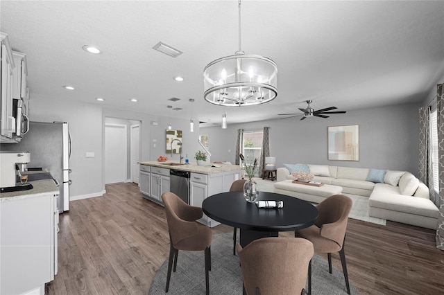 7036 Chatum Light Run, Bradenton, FL 34212 - dining area with a chandelier, dark wood-type flooring, a ceiling fan, and recessed lighting