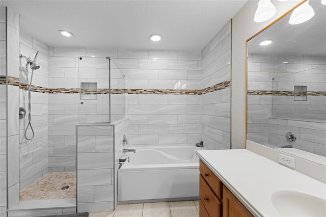 7036 Chatum Light Run, Bradenton, FL 34212 - bathroom featuring a tile shower, a garden tub, vanity, tile patterned floors, and recessed lighting