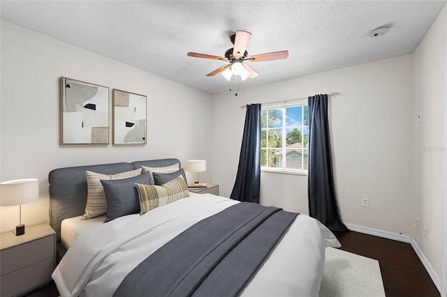 7036 Chatum Light Run, Bradenton, FL 34212 - bedroom with dark wood-style floors, a ceiling fan, and a textured ceiling