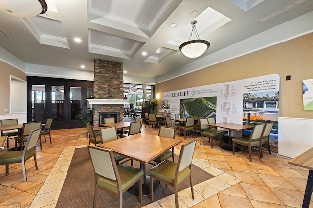 7036 Chatum Light Run, Bradenton, FL 34212 - dining area featuring coffered ceiling, plenty of natural light, beamed ceiling, stone tile flooring, and a fireplace