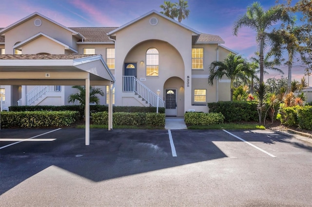 8335 Glenrose Way Unit 1513, Sarasota, FL 34238 - view of front facade with stairs, covered and uncovered parking, and stucco siding