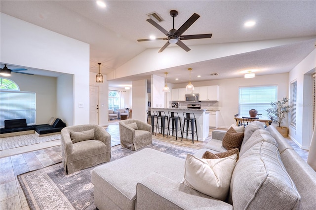 4204 Malickson Dr, Parrish, FL 34219 - living room with ceiling fan, light wood-type flooring, healthy amount of natural light, vaulted ceiling, and recessed lighting