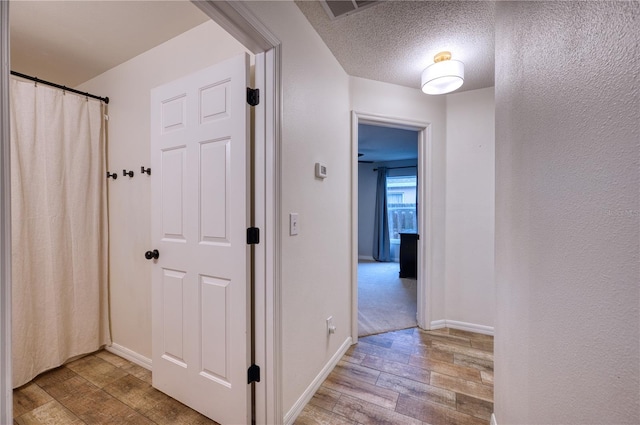 4204 Malickson Dr, Parrish, FL 34219 - corridor with wood finished floors and a textured ceiling