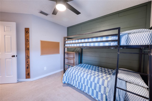 4204 Malickson Dr, Parrish, FL 34219 - carpeted bedroom with wood walls, vaulted ceiling, ceiling fan, and a textured ceiling