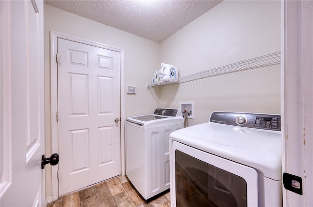 4204 Malickson Dr, Parrish, FL 34219 - laundry room with washer and dryer, light wood-style floors, and a textured ceiling