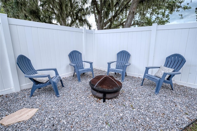 4204 Malickson Dr, Parrish, FL 34219 - fenced backyard featuring a fire pit and a patio area