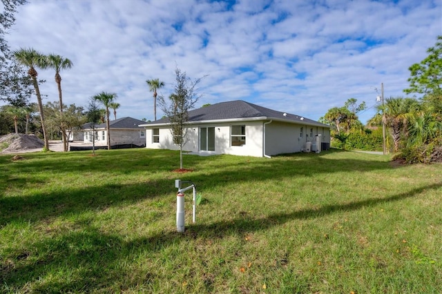 2703 Carmelia St, North Port, FL 34288 - back of property with a lawn and stucco siding