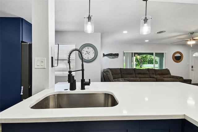 303 45th St W, Bradenton, FL 34209 - kitchen with blue cabinets, open floor plan, light countertops, a ceiling fan, and recessed lighting