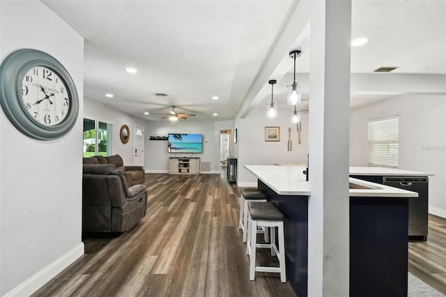 303 45th St W, Bradenton, FL 34209 - kitchen with dishwasher, dark wood-style floors, light countertops, open floor plan, and a breakfast bar