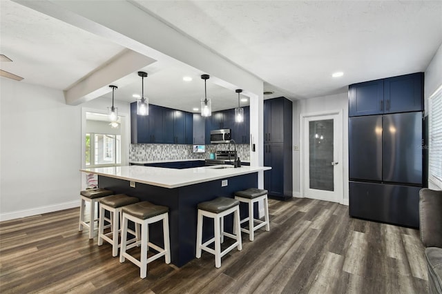 303 45th St W, Bradenton, FL 34209 - kitchen featuring stainless steel appliances, blue cabinetry, a kitchen bar, dark wood-type flooring, and recessed lighting