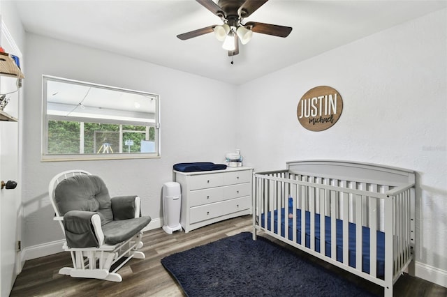 303 45th St W, Bradenton, FL 34209 - bedroom featuring wood finished floors, a crib, and a ceiling fan