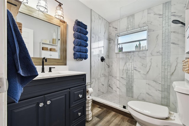 303 45th St W, Bradenton, FL 34209 - bathroom featuring vanity, a marble finish shower, and wood finished floors