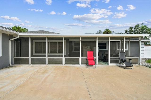 303 45th St W, Bradenton, FL 34209 - rear view of property featuring a sunroom and a patio area