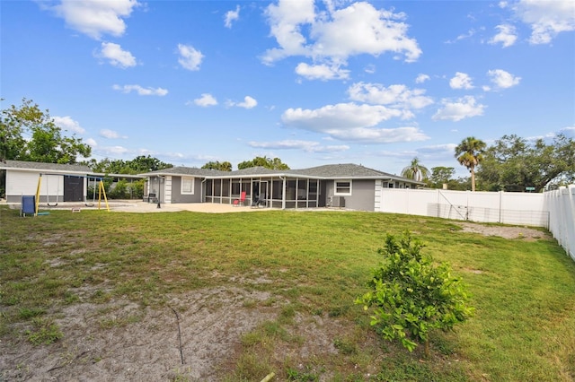 303 45th St W, Bradenton, FL 34209 - back of house featuring a sunroom, a patio area, a fenced backyard, and a carport