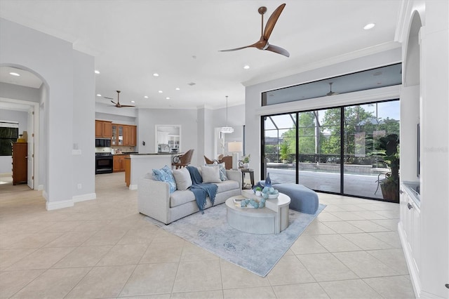 13818 Milan Ter, Lakewood Ranch, FL 34202 - living room with a ceiling fan, light tile patterned flooring, crown molding, recessed lighting, and arched walkways