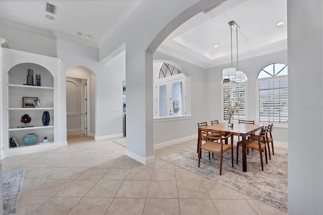 13818 Milan Ter, Lakewood Ranch, FL 34202 - dining space featuring built in features, arched walkways, light tile patterned floors, ornamental molding, and a chandelier