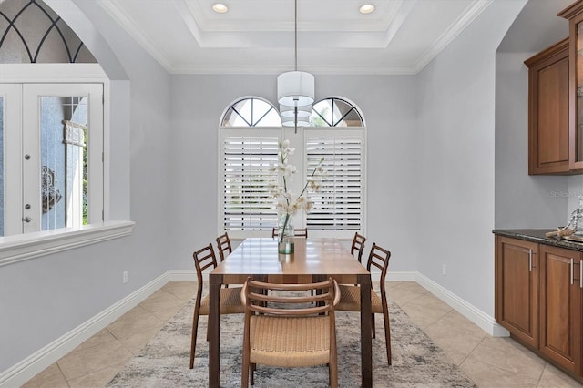13818 Milan Ter, Lakewood Ranch, FL 34202 - dining room featuring plenty of natural light, a tray ceiling, light tile patterned flooring, arched walkways, and crown molding