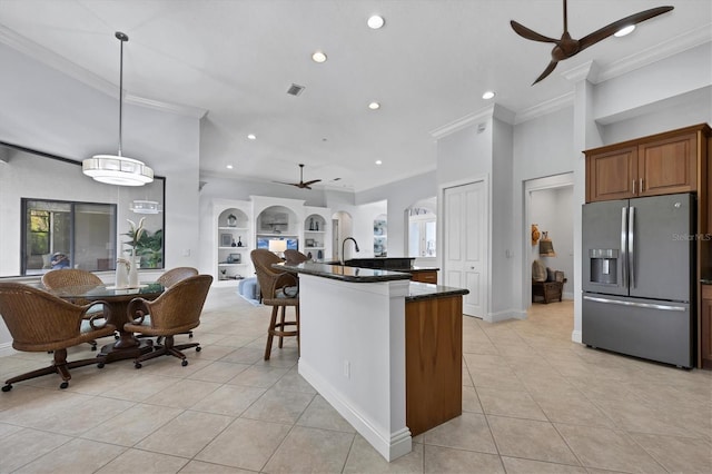 13818 Milan Ter, Lakewood Ranch, FL 34202 - kitchen featuring stainless steel fridge, a ceiling fan, crown molding, light tile patterned floors, and open floor plan