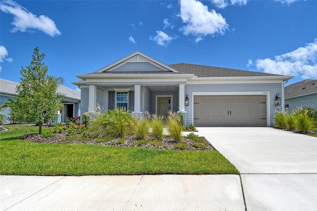 14312 Skipping Stone Loop, Parrish, FL 34219 - view of front of property featuring a garage, driveway, and a front yard