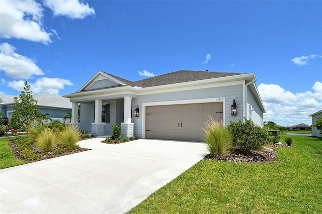 14312 Skipping Stone Loop, Parrish, FL 34219 - view of front of home featuring an attached garage, a front lawn, and driveway