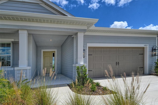 14312 Skipping Stone Loop, Parrish, FL 34219 - property entrance with a garage and concrete driveway