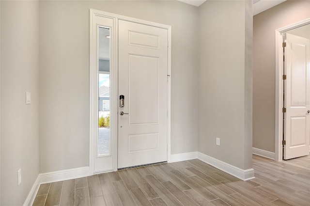 14312 Skipping Stone Loop, Parrish, FL 34219 - entryway featuring wood tiled floors and baseboards