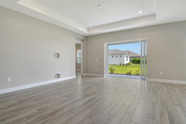 14312 Skipping Stone Loop, Parrish, FL 34219 - unfurnished room featuring a raised ceiling, light wood finished floors, and recessed lighting