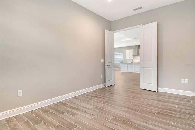 14312 Skipping Stone Loop, Parrish, FL 34219 - spare room with light wood finished floors and recessed lighting