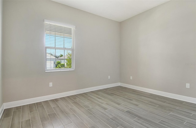 14312 Skipping Stone Loop, Parrish, FL 34219 - empty room featuring baseboards and wood finish floors