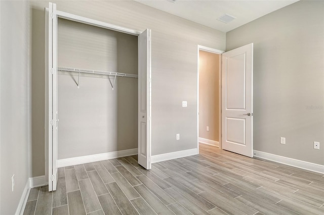 14312 Skipping Stone Loop, Parrish, FL 34219 - unfurnished bedroom with wood tiled floors and a closet
