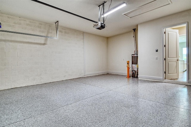 14312 Skipping Stone Loop, Parrish, FL 34219 - garage featuring a garage door opener, gas water heater, and concrete block wall