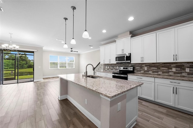5174 78th St Cir E, Bradenton, FL 34203 - kitchen featuring stainless steel appliances, a chandelier, ornamental molding, tasteful backsplash, and dark wood finished floors