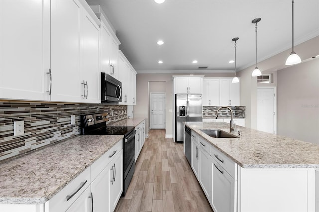 5174 78th St Cir E, Bradenton, FL 34203 - kitchen with appliances with stainless steel finishes, white cabinetry, light wood-style flooring, backsplash, and recessed lighting