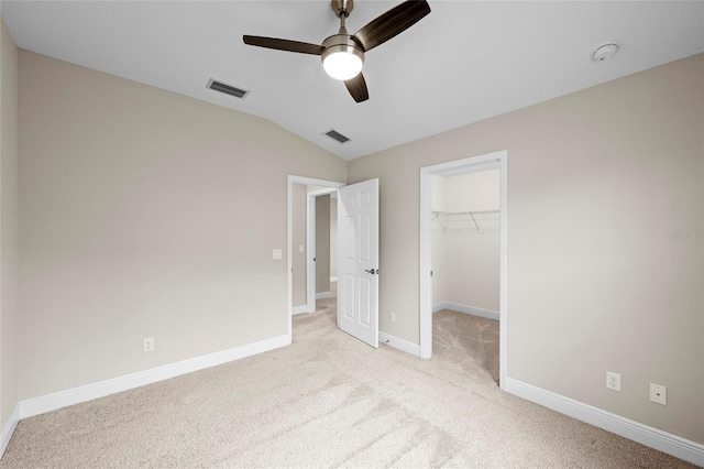 5174 78th St Cir E, Bradenton, FL 34203 - unfurnished bedroom with light carpet, lofted ceiling, a spacious closet, a closet, and ceiling fan