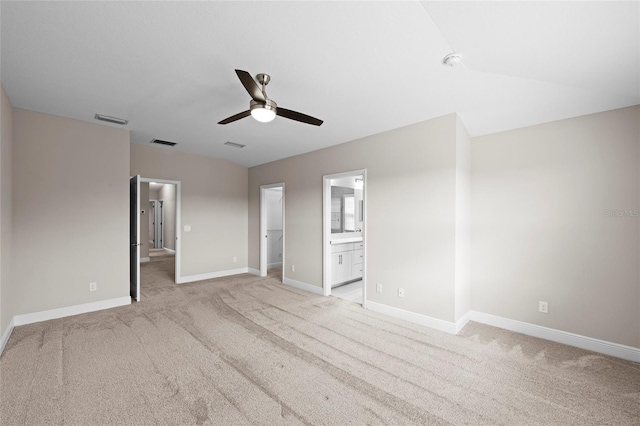 5174 78th St Cir E, Bradenton, FL 34203 - unfurnished bedroom featuring light colored carpet, a spacious closet, ensuite bathroom, and a ceiling fan