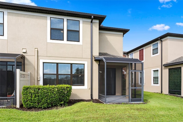 5174 78th St Cir E, Bradenton, FL 34203 - back of property featuring stucco siding, a yard, and a sunroom