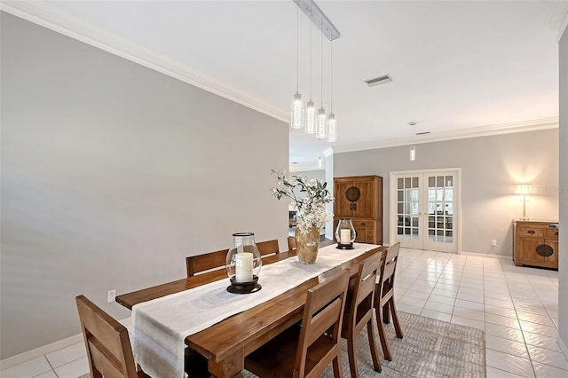 7868 Chick Evans Pl, Sarasota, FL 34240 - dining space featuring light tile patterned flooring, crown molding, and french doors