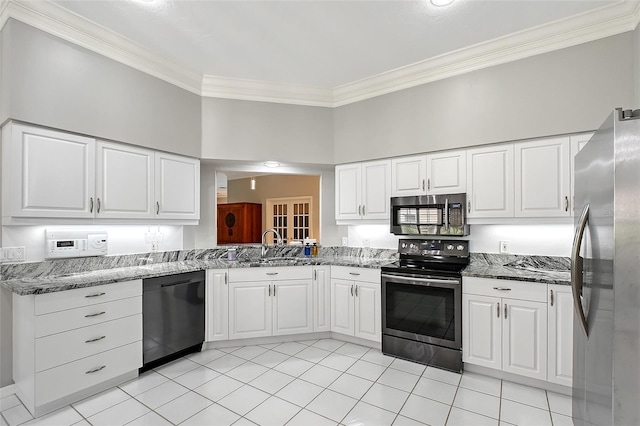 7868 Chick Evans Pl, Sarasota, FL 34240 - kitchen featuring stainless steel appliances, ornamental molding, light tile patterned floors, dark stone counters, and white cabinetry