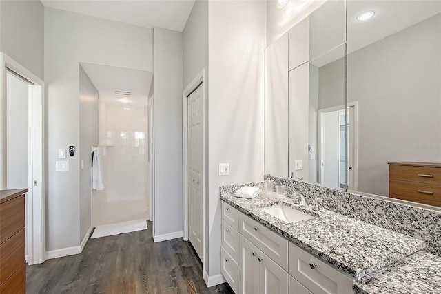 7868 Chick Evans Pl, Sarasota, FL 34240 - bathroom with vanity, walk in shower, and wood finished floors