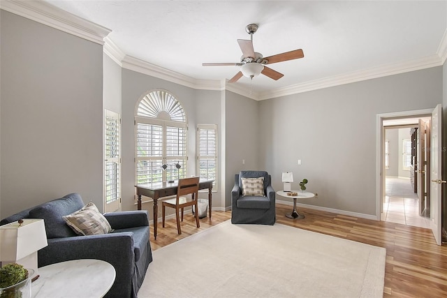 7868 Chick Evans Pl, Sarasota, FL 34240 - sitting room featuring crown molding, plenty of natural light, light wood-style floors, and a ceiling fan