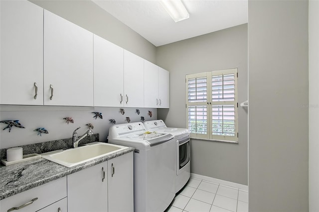 7868 Chick Evans Pl, Sarasota, FL 34240 - laundry room with cabinet space, washing machine and clothes dryer, and light tile patterned floors